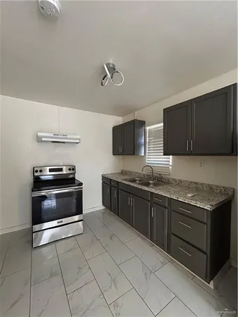 a kitchen with stainless steel appliances granite countertop a stove and a microwave
