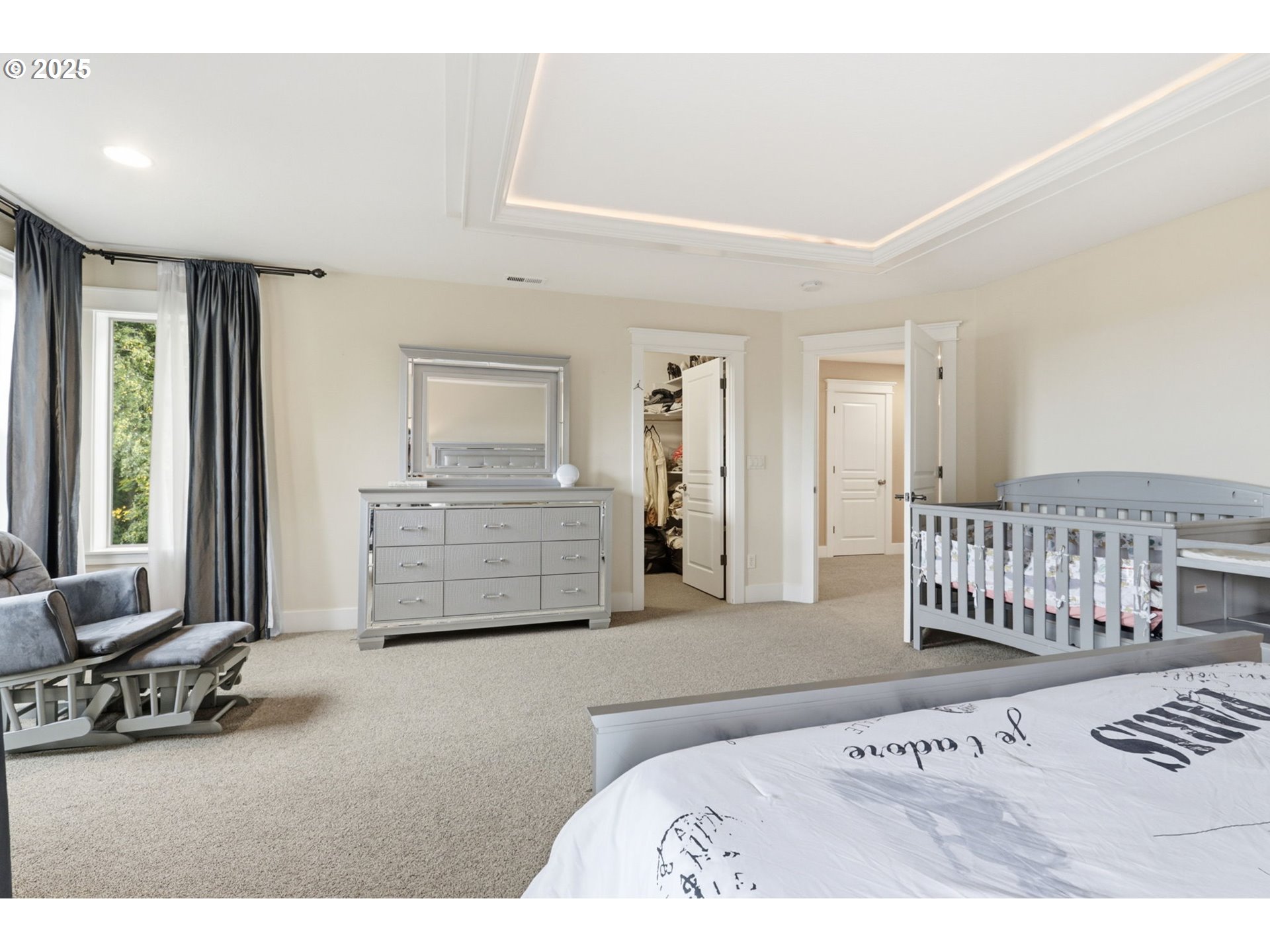 937 Southwest Florence Court Gresham, OR 97080 - Photo 19 of 47 a spacious bedroom with a bed a couch and a large window