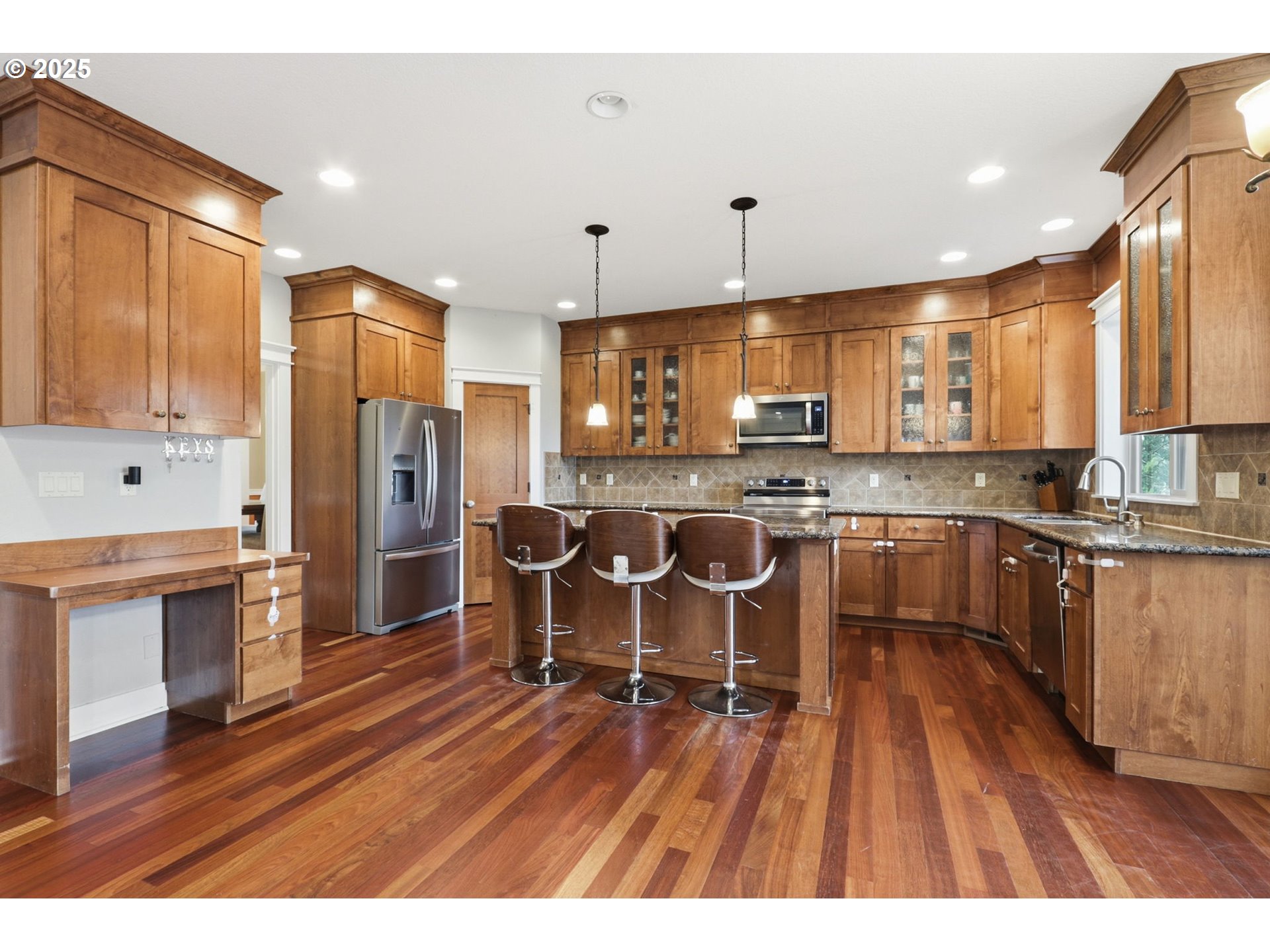 937 Southwest Florence Court Gresham, OR 97080 - Photo 6 of 47 a open kitchen with stainless steel appliances granite countertop a refrigerator a sink dishwasher a stove and a dining table with wooden floor