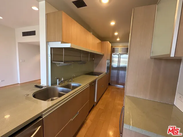 a kitchen with a sink a counter top space and cabinets