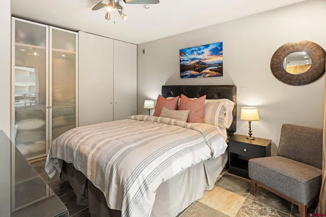 a bedroom with a bed and a chandelier