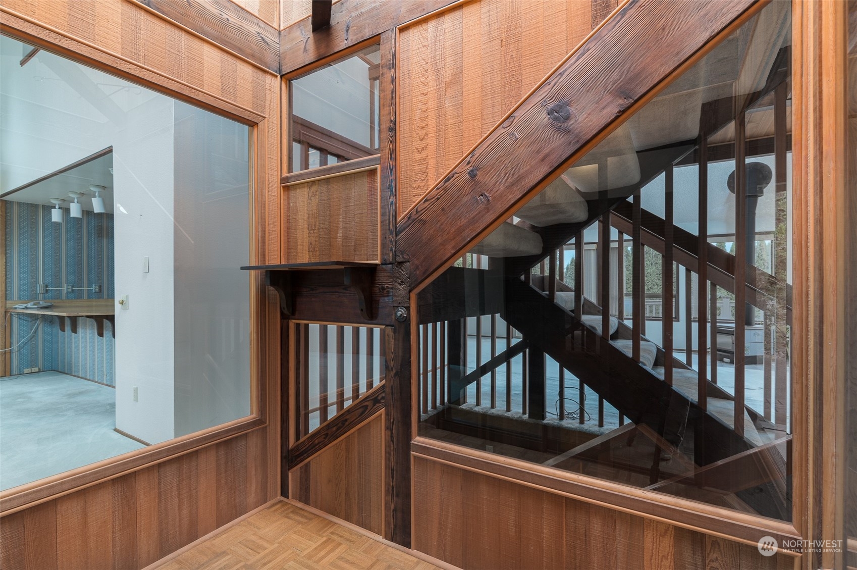 243 Bayside Road Bellingham, WA 98225 - Photo 19 of 22 a view of staircase with lots of frames on wall and a wooden floor