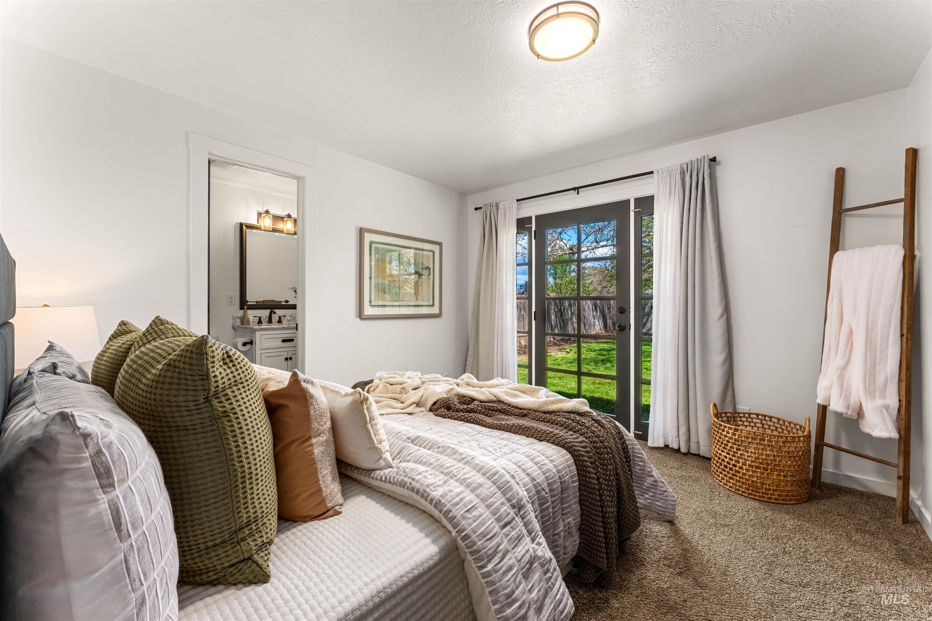 4700 Jennifer Street Boise, ID 83704 - Photo 18 of 39 Bedroom featuring a ceiling-mounted flush light fixture, carpeted flooring, and a glass-paned exterior door