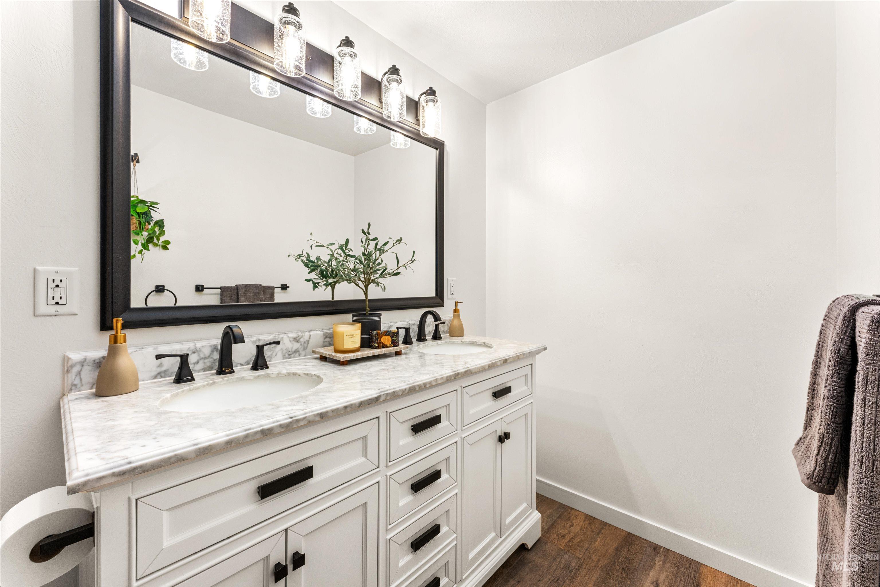 4700 Jennifer Street Boise, ID 83704 - Photo 23 of 39 Dual-sink vanity featuring a white cabinetry, light-toned countertop, and dark-finish hardware