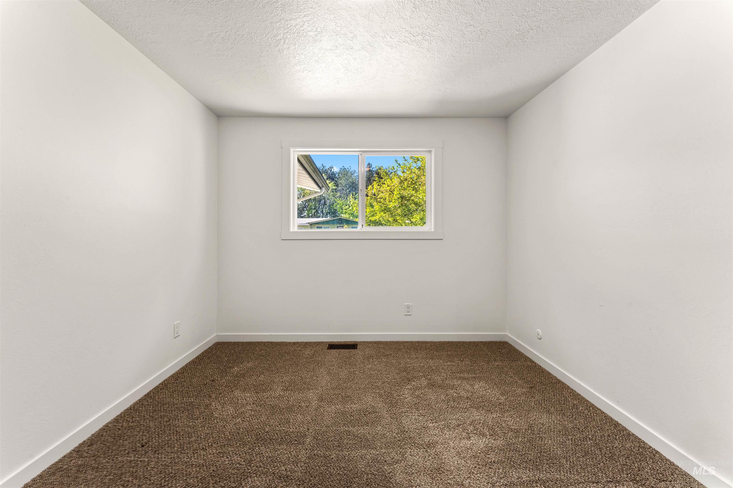 4700 Jennifer Street Boise, ID 83704 - Photo 27 of 39 Bright interior space featuring a single window, white walls, and brown carpet flooring