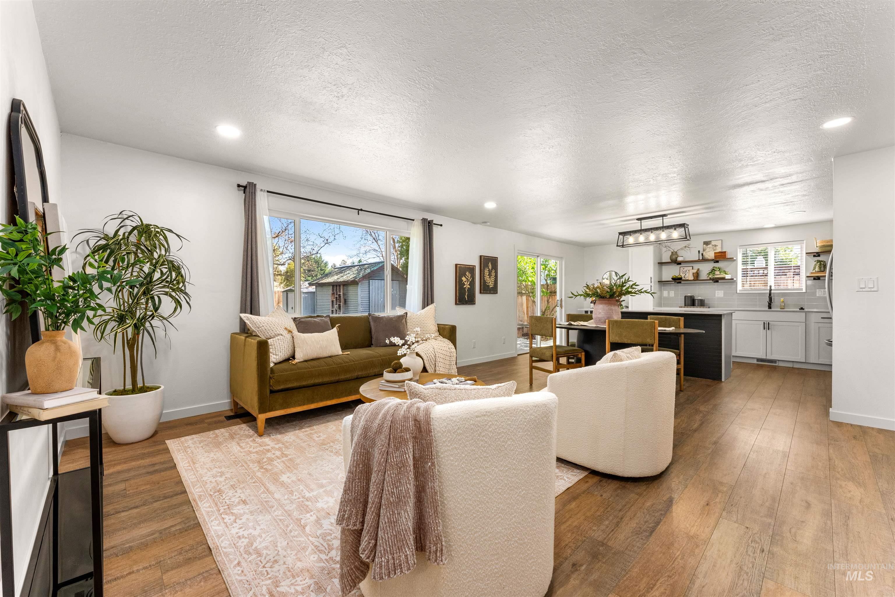 4700 Jennifer Street Boise, ID 83704 - Photo 3 of 39 Open-concept living space featuring wood-finish flooring, recessed lighting, and white wall finishes