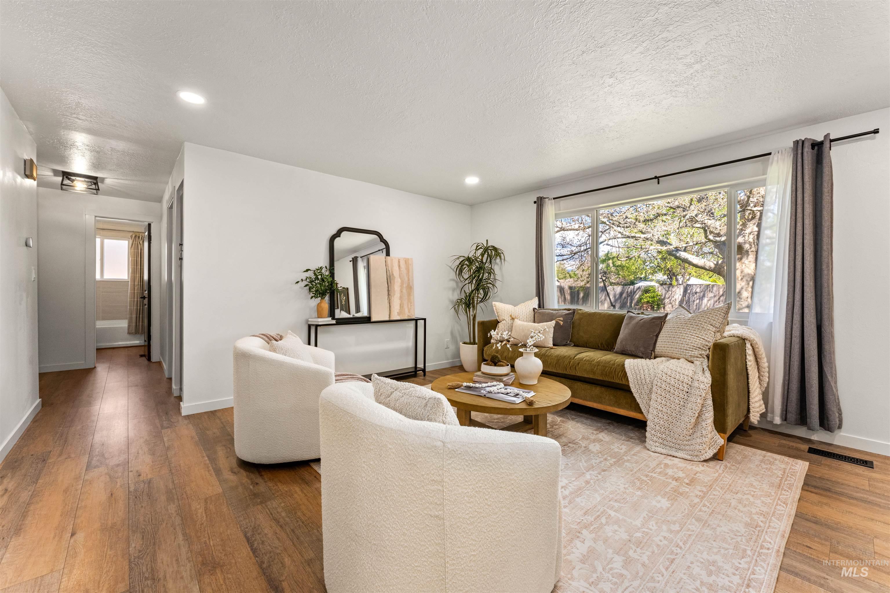 4700 Jennifer Street Boise, ID 83704 - Photo 5 of 39 Bright living space featuring wood-finish flooring and a large picture window