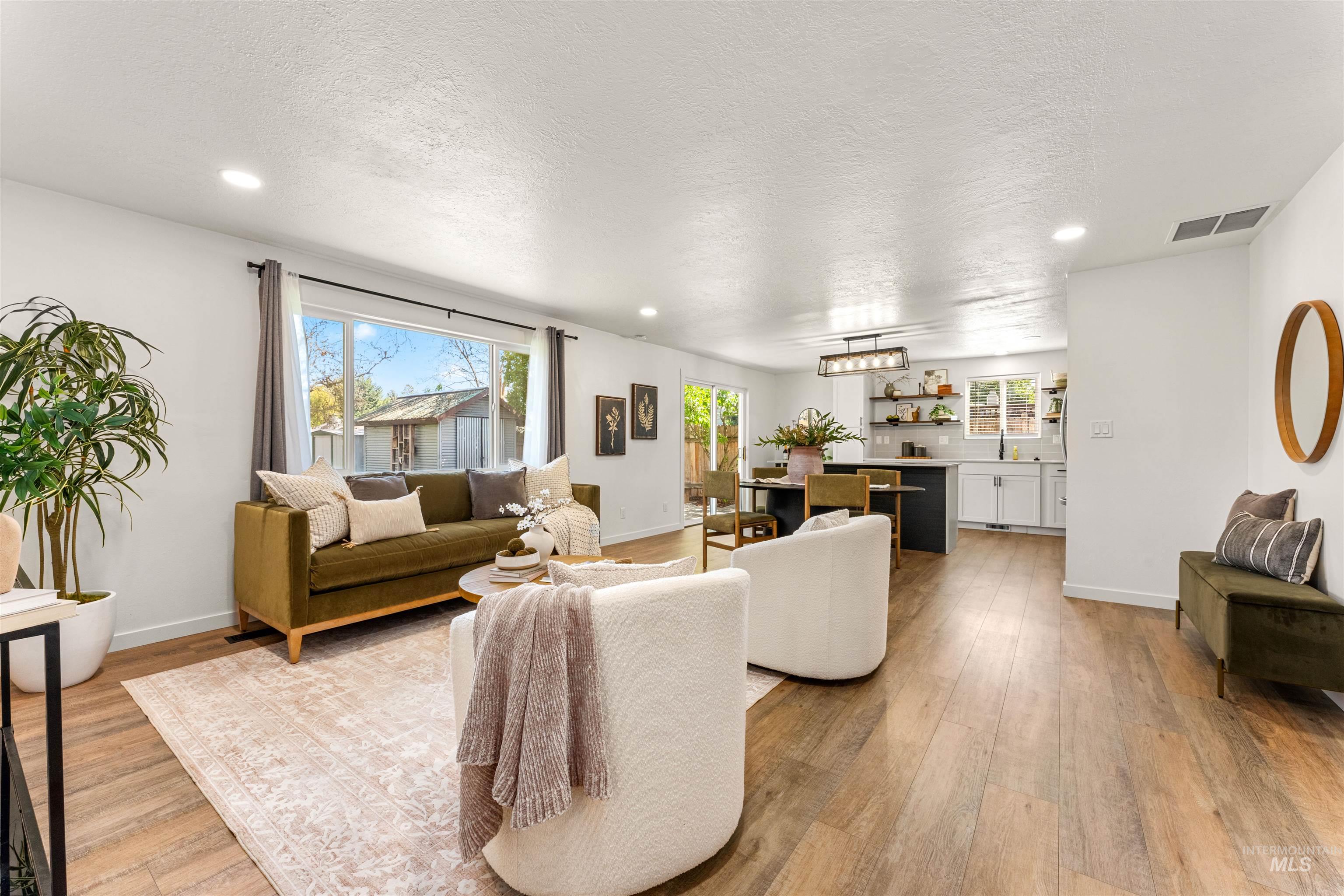 4700 Jennifer Street Boise, ID 83704 - Photo 6 of 39 Spacious living area featuring wood-finish flooring, recessed lighting, and a large window