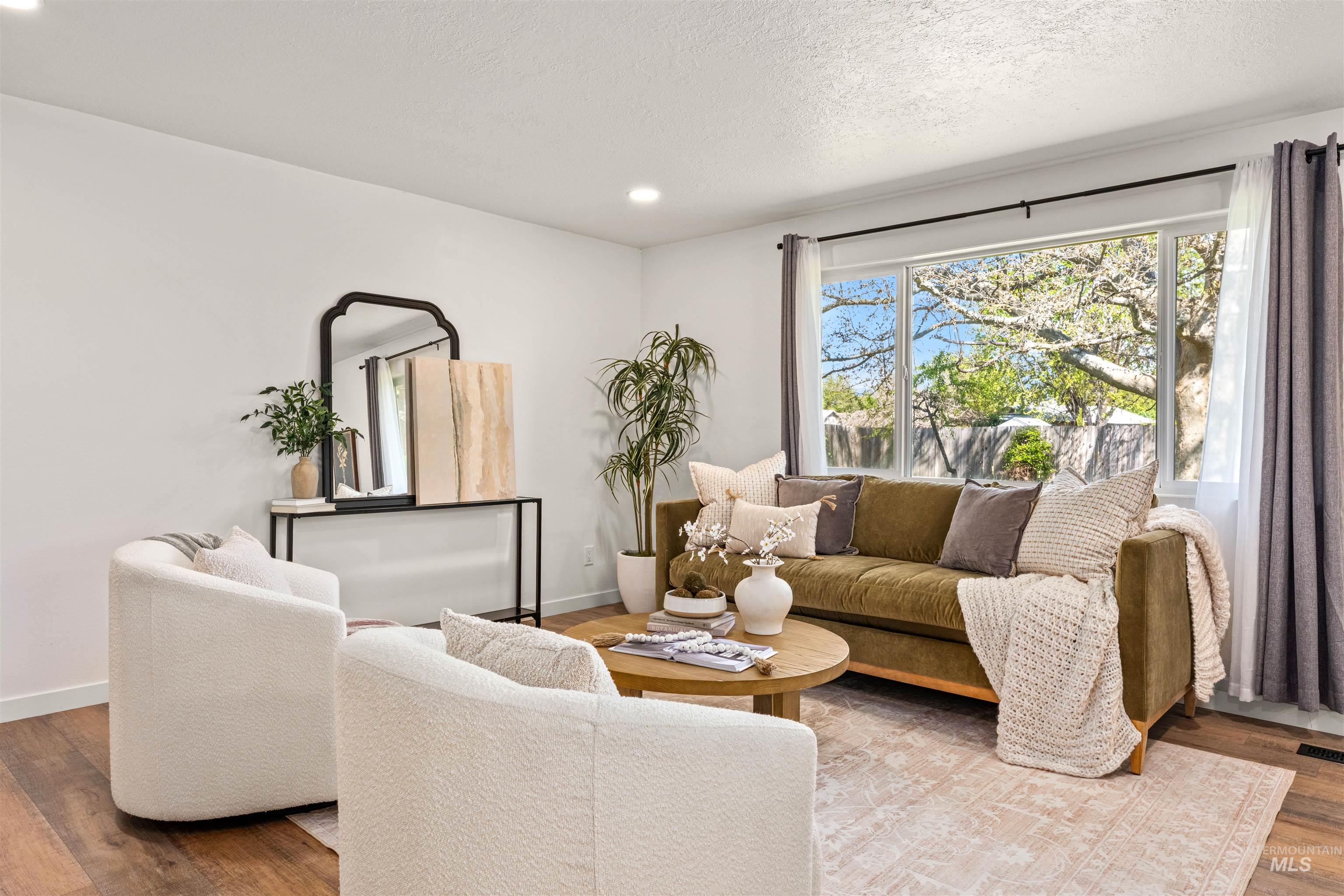 4700 Jennifer Street Boise, ID 83704 - Photo 8 of 39 Spacious living area featuring wood-finish flooring, recessed lighting, and a large window