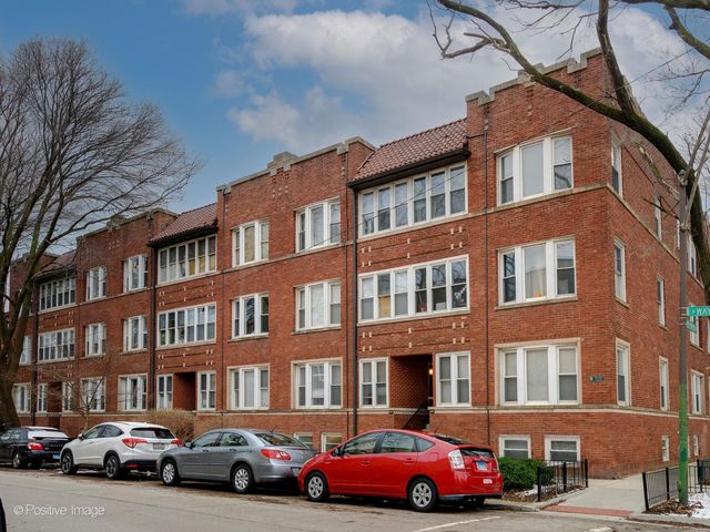 a cars parked in front of a brick building