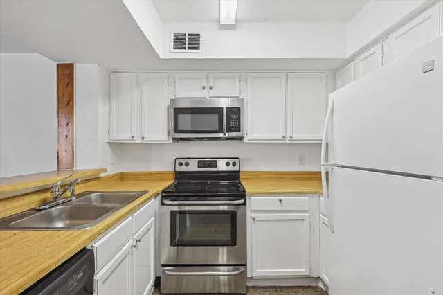 a kitchen with a refrigerator stove and microwave