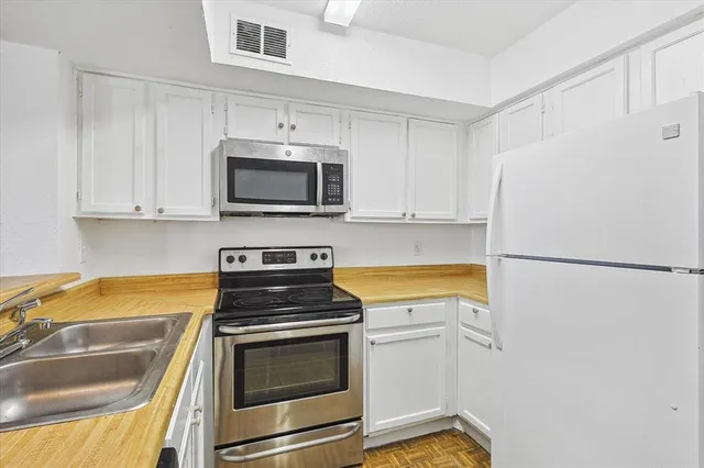 a kitchen with a refrigerator stove and microwave