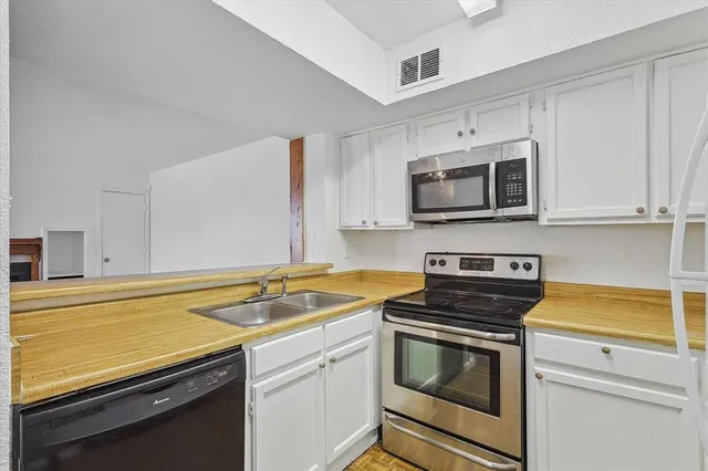 a kitchen with a sink stove and microwave