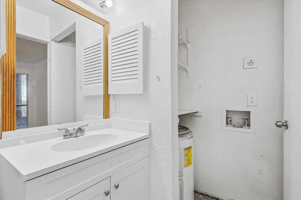 9821 Walnut Street, Unit 101 Dallas, TX 75243 - Photo 15 of 17 a bathroom with a sink and a mirror