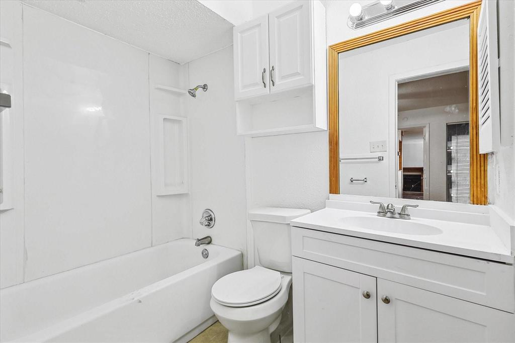 9821 Walnut Street, Unit 101 Dallas, TX 75243 - Photo 16 of 17 a bathroom with a sink a toilet and a bathtub
