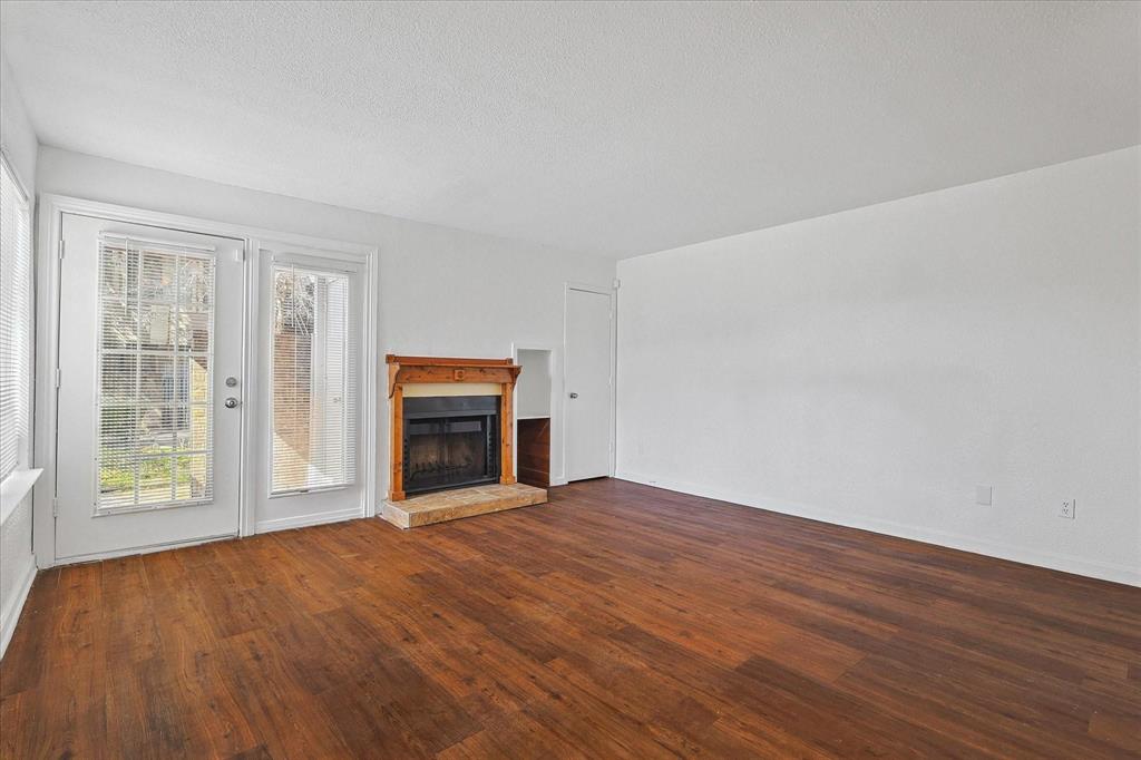 9821 Walnut Street, Unit 101 Dallas, TX 75243 - Photo 5 of 17 a view of an empty room with a window and fireplace