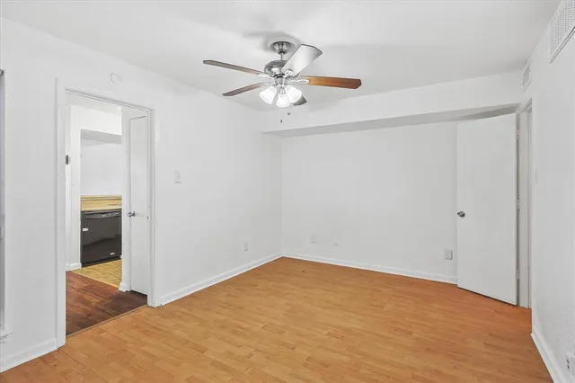 a view of a room with a ceiling fan and closet
