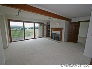 190 Kings Grant Road, Unit 211 Rutherfordton, NC 28139 - Photo 1 of 12 a view of an empty room with a fireplace and a window