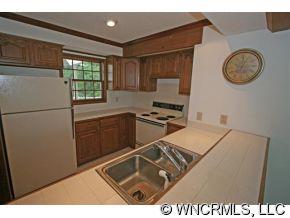 190 Kings Grant Road, Unit 211 Rutherfordton, NC 28139 - Photo 5 of 12 a kitchen with a refrigerator and a stove top oven
