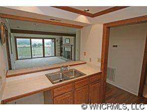 190 Kings Grant Road, Unit 211 Rutherfordton, NC 28139 - Photo 6 of 12 a kitchen with a sink and a large mirror