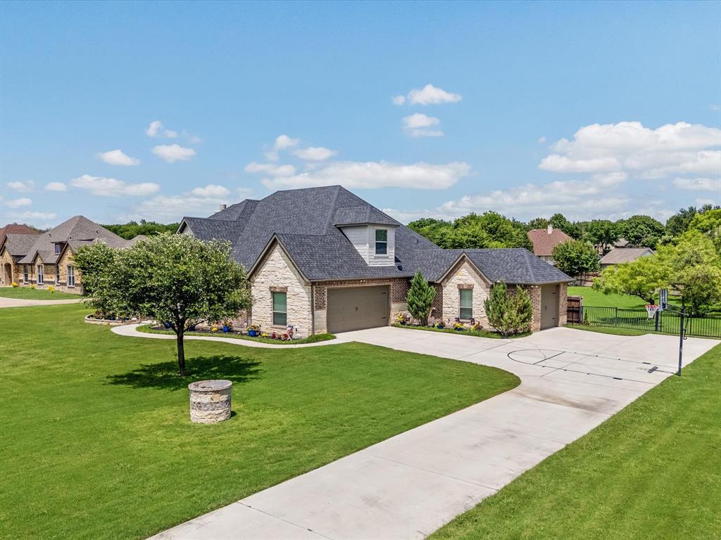 111 Old Base Road Aurora, TX 76078 - Photo 3 of 38 Beautifully updated custom home situated on a one-acre lot in Aurora Vista with mature landscaping, stone accents, and exceptional curb appeal.