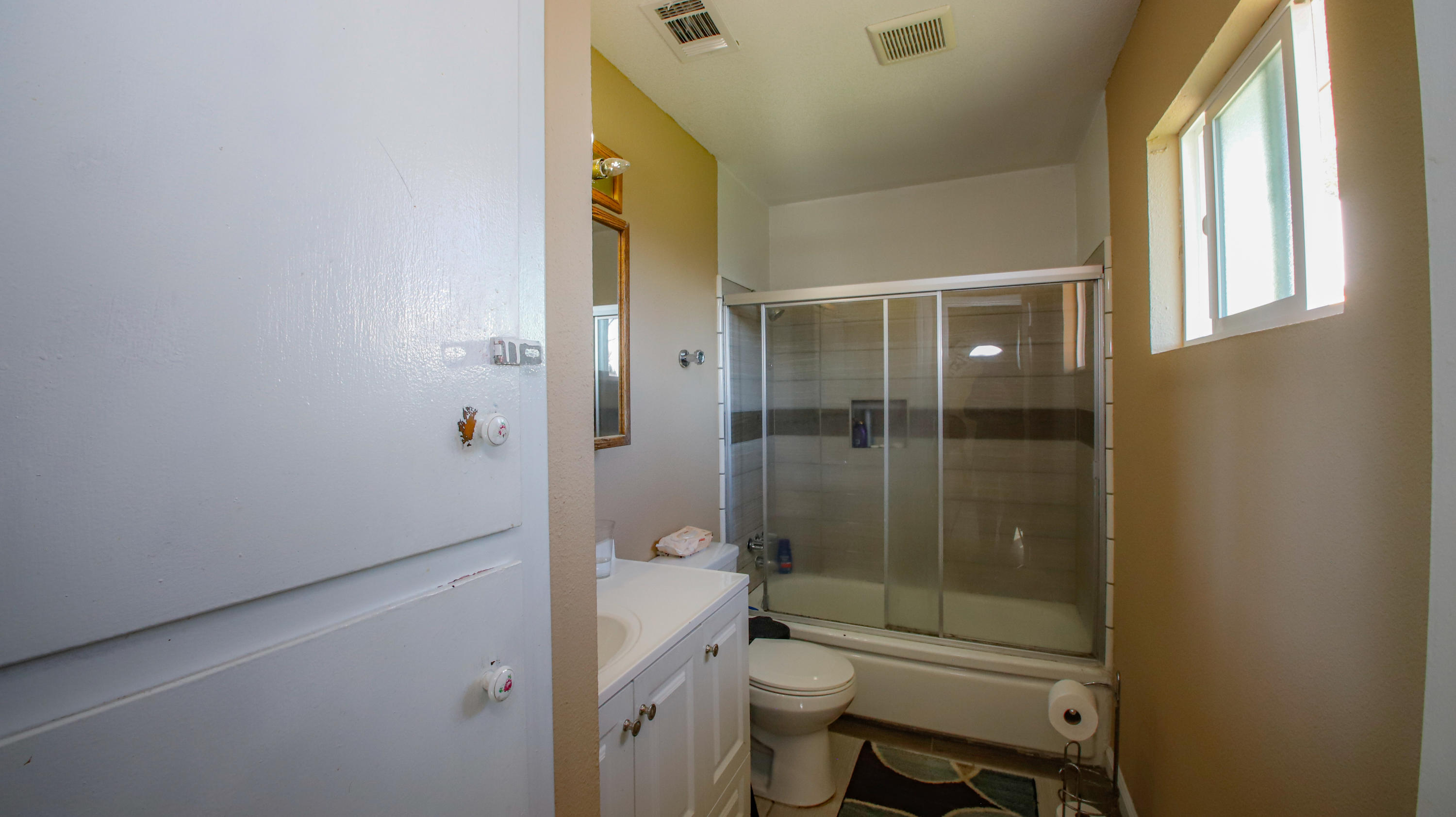 7441 Pacheco Road Redding, CA 96002 - Photo 12 of 19 a bathroom with a granite countertop toilet a sink and shower