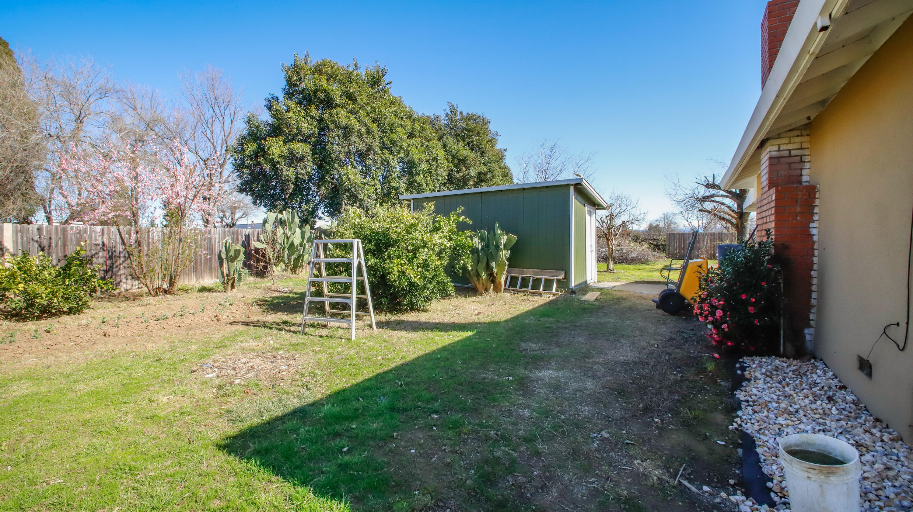 7441 Pacheco Road Redding, CA 96002 - Photo 16 of 19 a view of a backyard with table and chairs and potted plants