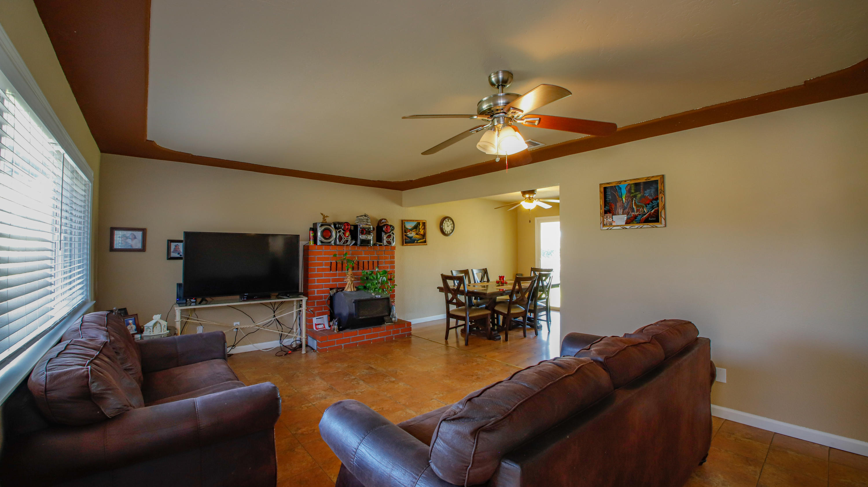 7441 Pacheco Road Redding, CA 96002 - Photo 4 of 19 a living room with furniture and a flat screen tv with kitchen view