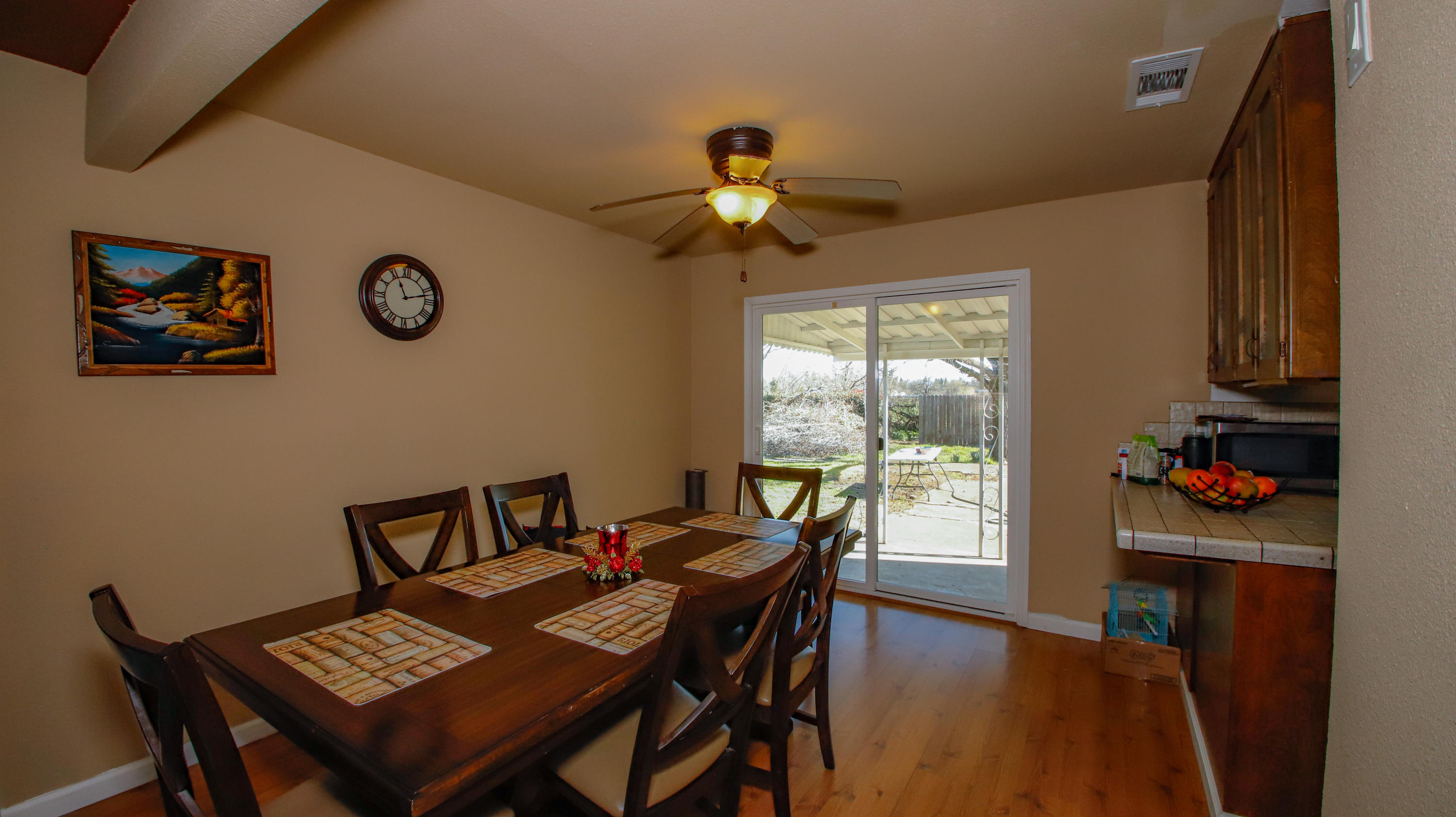 7441 Pacheco Road Redding, CA 96002 - Photo 5 of 19 a view of a dining room with furniture wooden floor and a chandelier