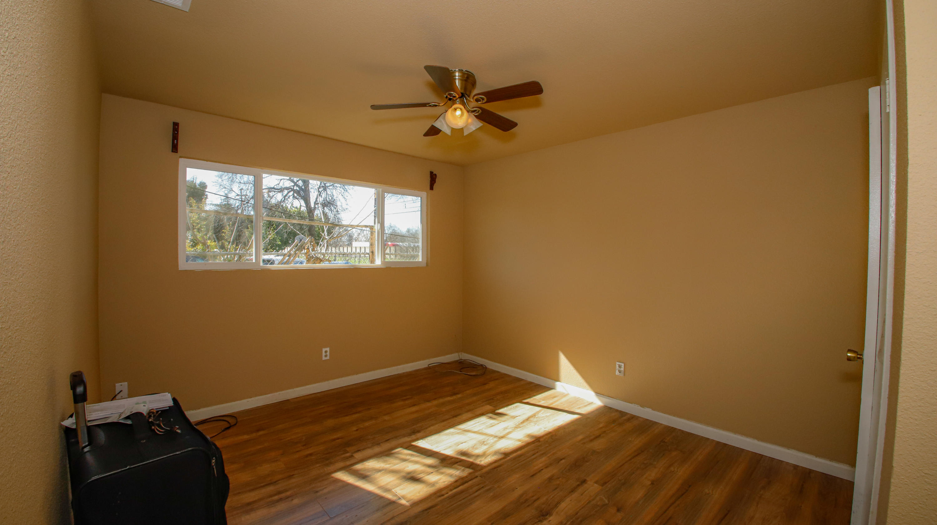 7441 Pacheco Road Redding, CA 96002 - Photo 10 of 19 a view of empty room with wooden floor and fan