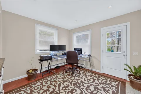 a work room with furniture lamp and window