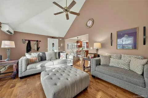 a living room with furniture and a view of kitchen