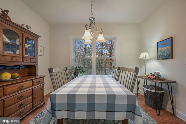 a bedroom with a bed a dresser and next to a window