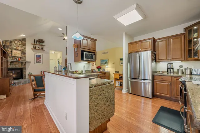 a kitchen with stainless steel appliances granite countertop a refrigerator stove microwave and sink