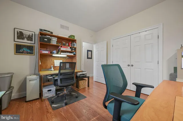 a view of a workspace with furniture and wooden floor