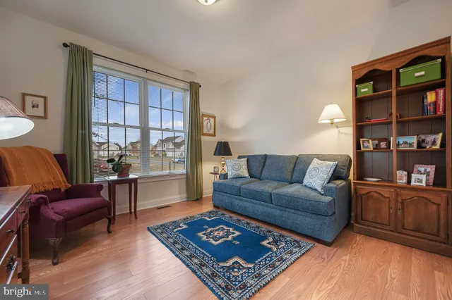 a living room with furniture and a book shelf