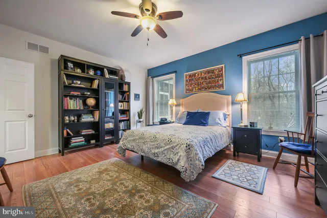 a bedroom with a bed furniture and a book shelf