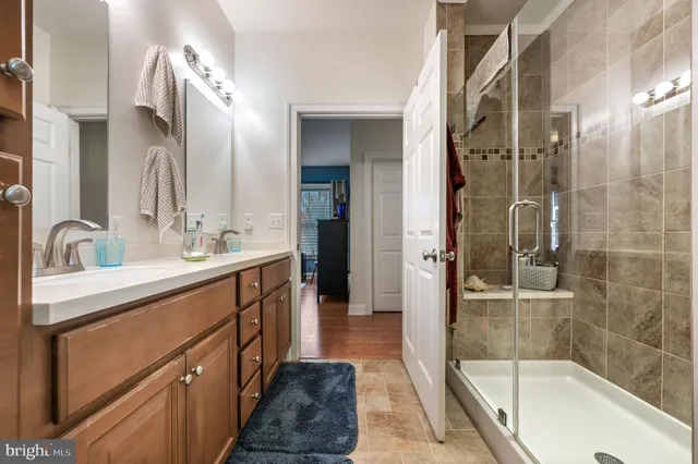 a spacious bathroom with a bathtub shower sink mirror and vanity