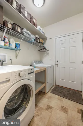 a utility room with cabinets dryer and washer
