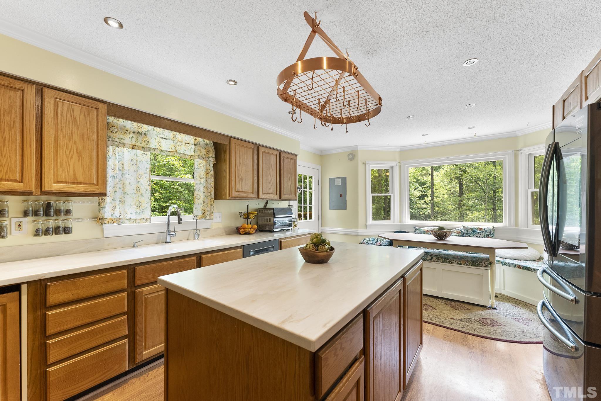11416 Hickory Grove Church Road Raleigh, NC 27613 - Photo 7 of 40 a kitchen with a stove a sink and a refrigerator