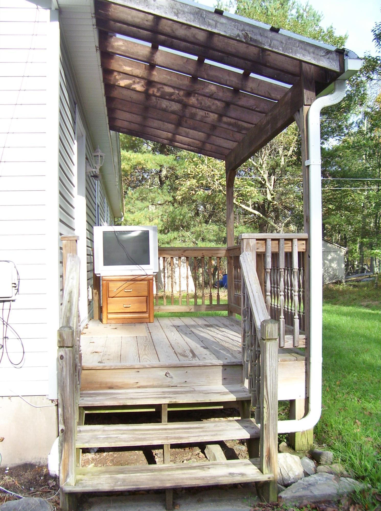 13 W Road Hawley, PA 18428 - Photo 24 of 26 a view of a wooden deck with a big yard