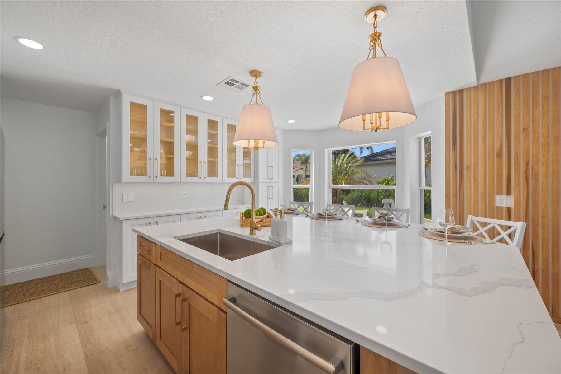 4185 Sea Mist Way Wellington, FL 33449 - Photo 16 of 50 a kitchen with a sink and a wooden floor