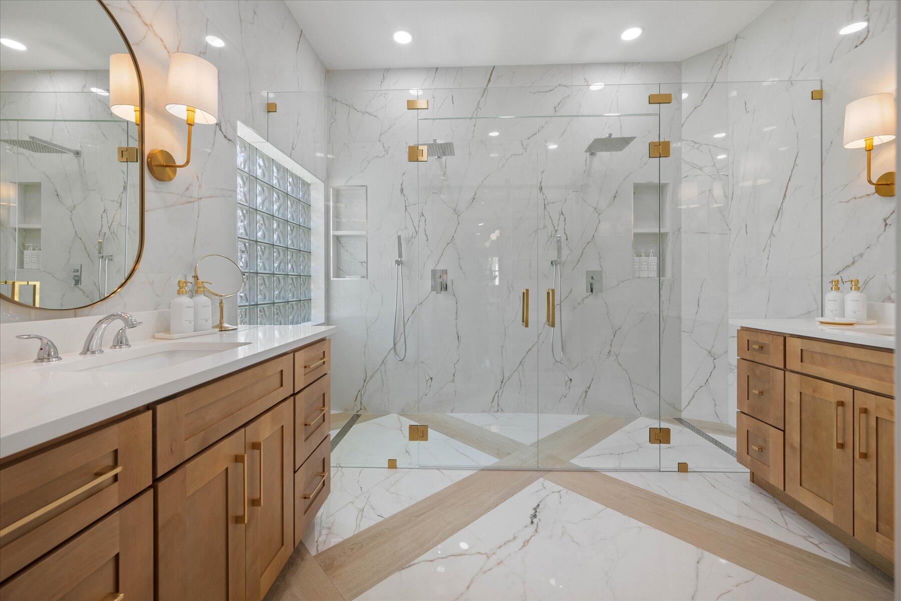 4185 Sea Mist Way Wellington, FL 33449 - Photo 25 of 50 a spacious bathroom with a granite countertop sink mirror and shower