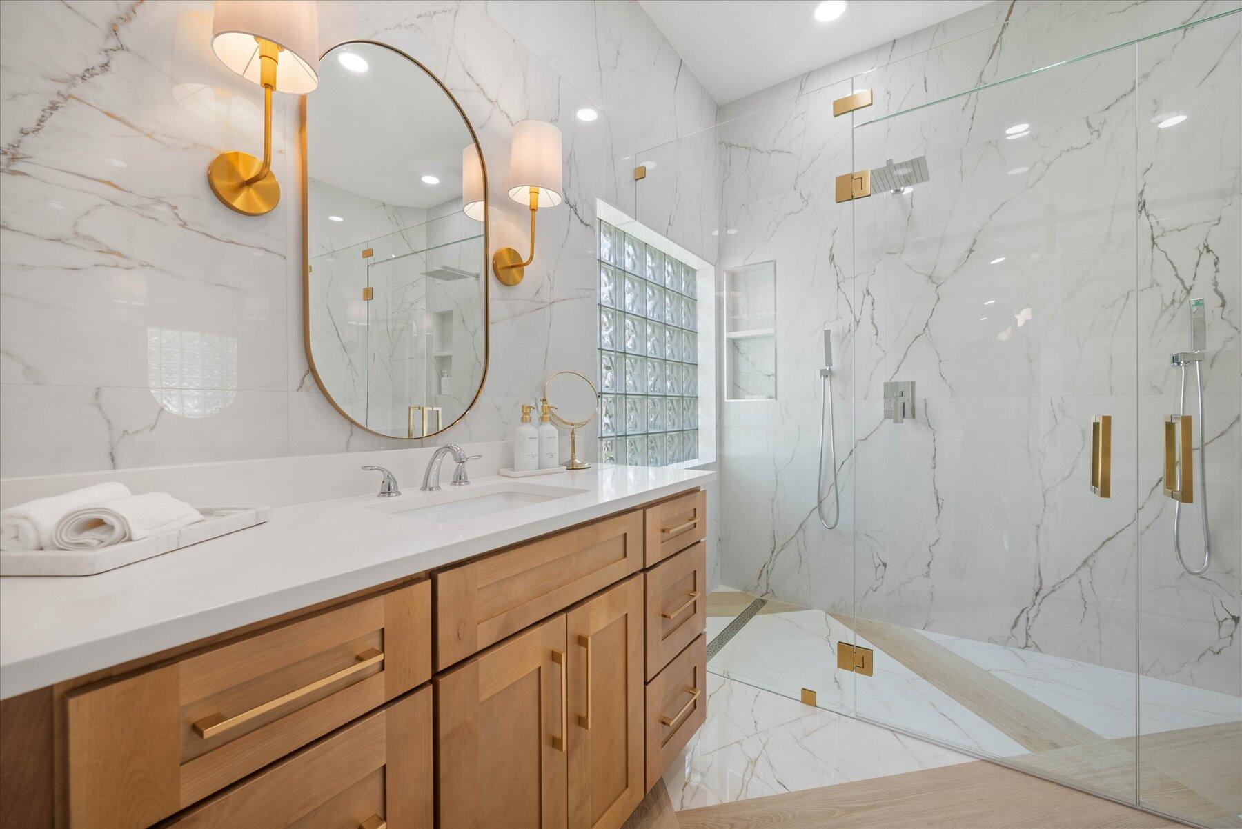 4185 Sea Mist Way Wellington, FL 33449 - Photo 26 of 50 a bathroom with a sink a vanity a mirror and a shower