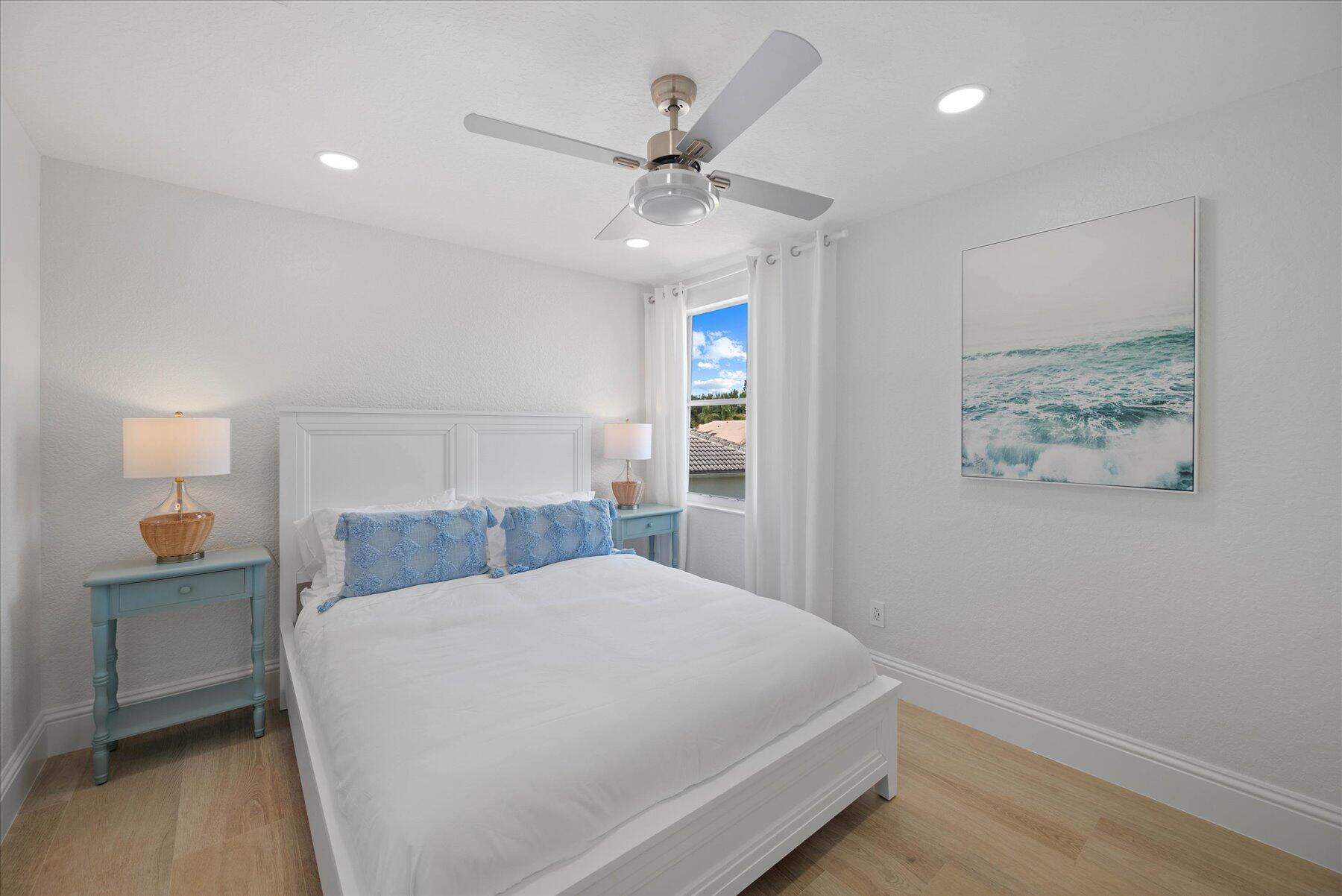 4185 Sea Mist Way Wellington, FL 33449 - Photo 36 of 50 a bedroom with a large bed and a chandelier