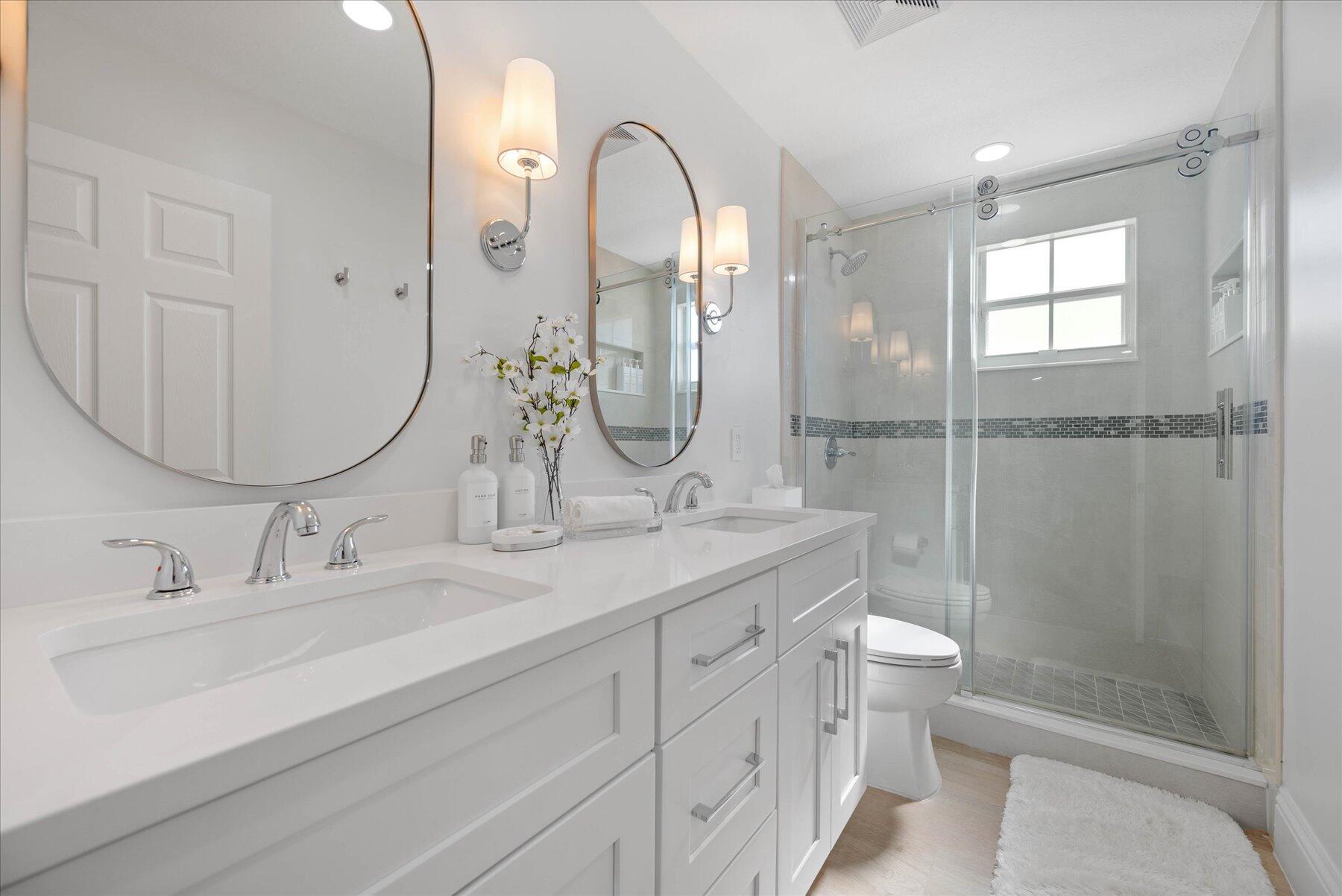 4185 Sea Mist Way Wellington, FL 33449 - Photo 37 of 50 a bathroom with a double vanity sink toilet and shower