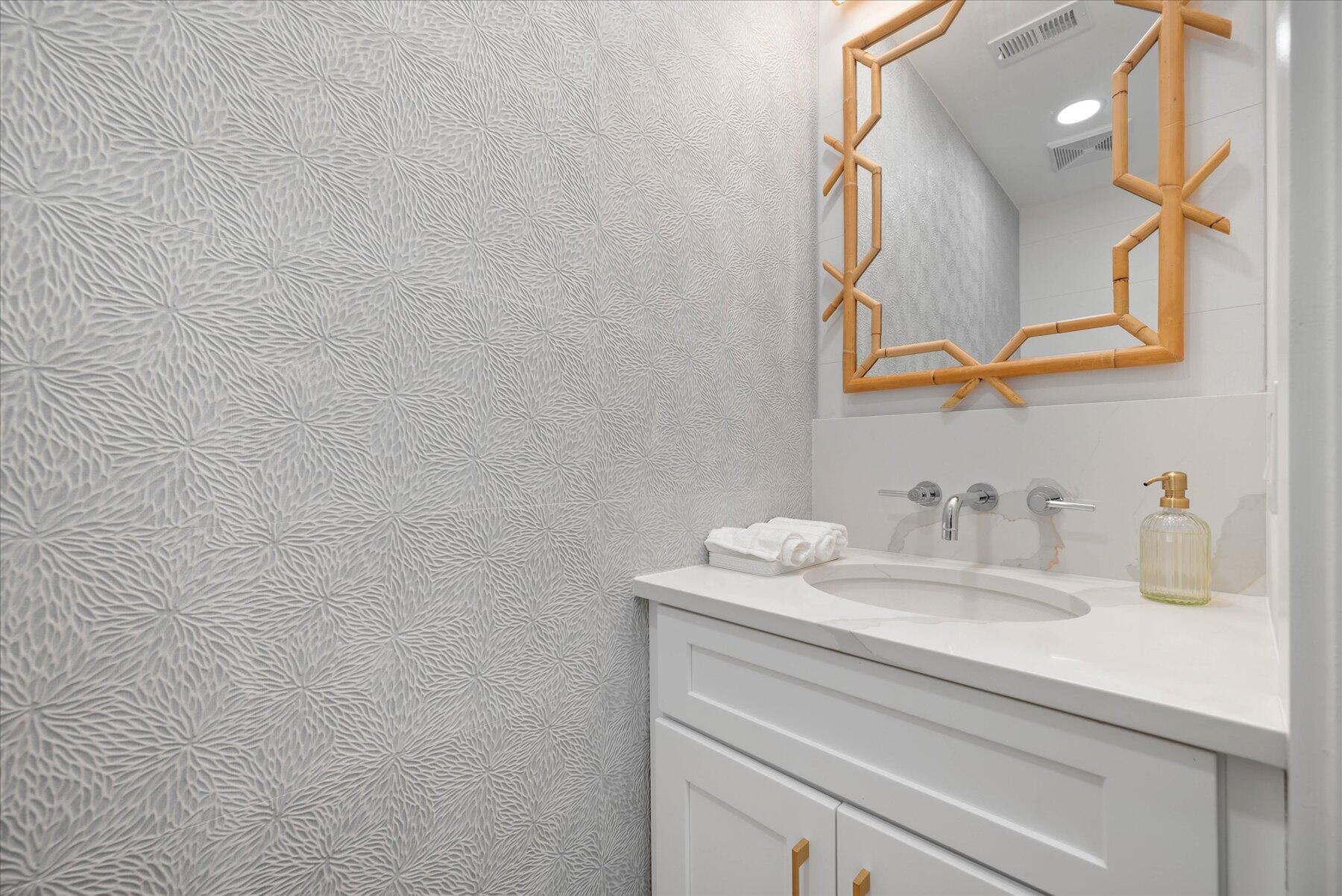 4185 Sea Mist Way Wellington, FL 33449 - Photo 40 of 50 a bathroom with a sink and a mirror