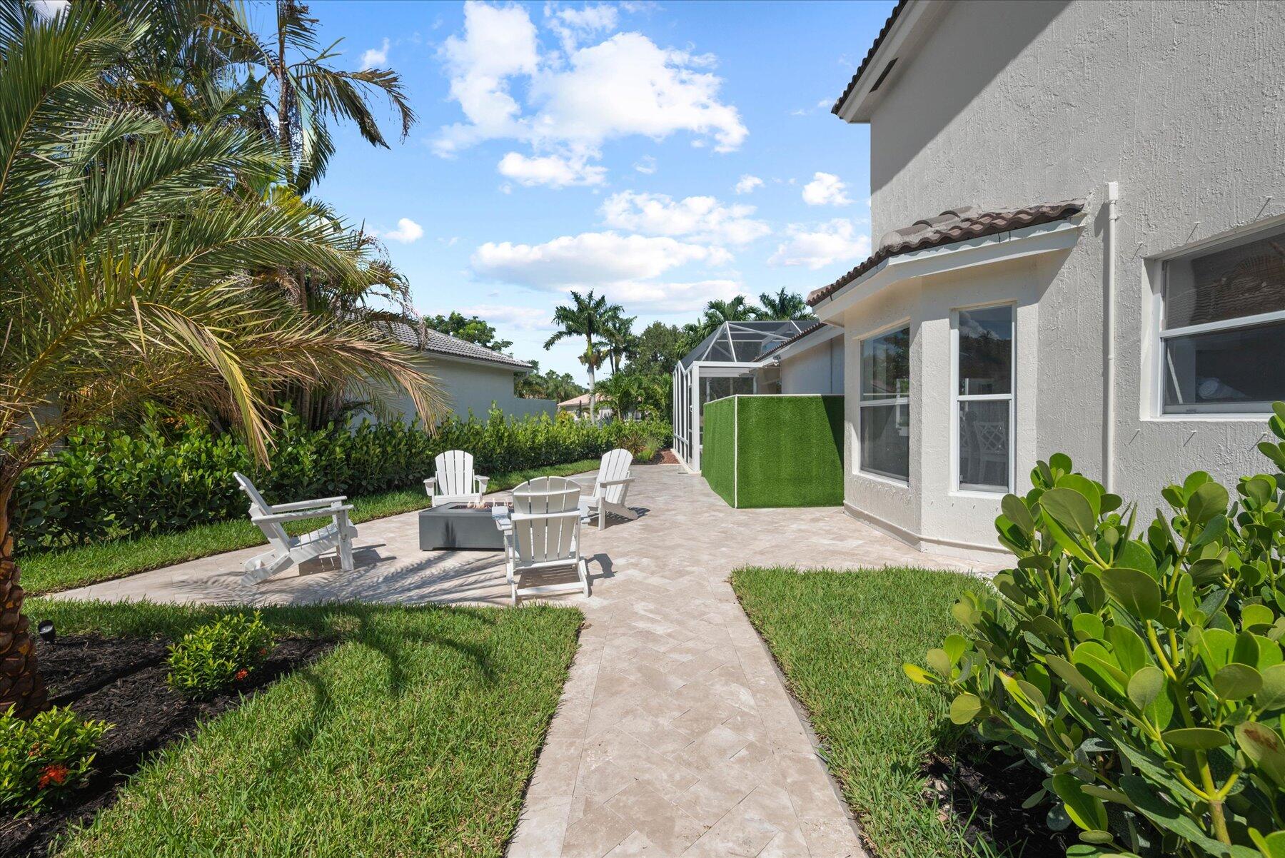 4185 Sea Mist Way Wellington, FL 33449 - Photo 47 of 50 a view of a patio with couches table and chairs and potted plants