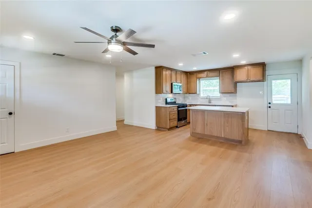 a view of kitchen with wooden floor and window
