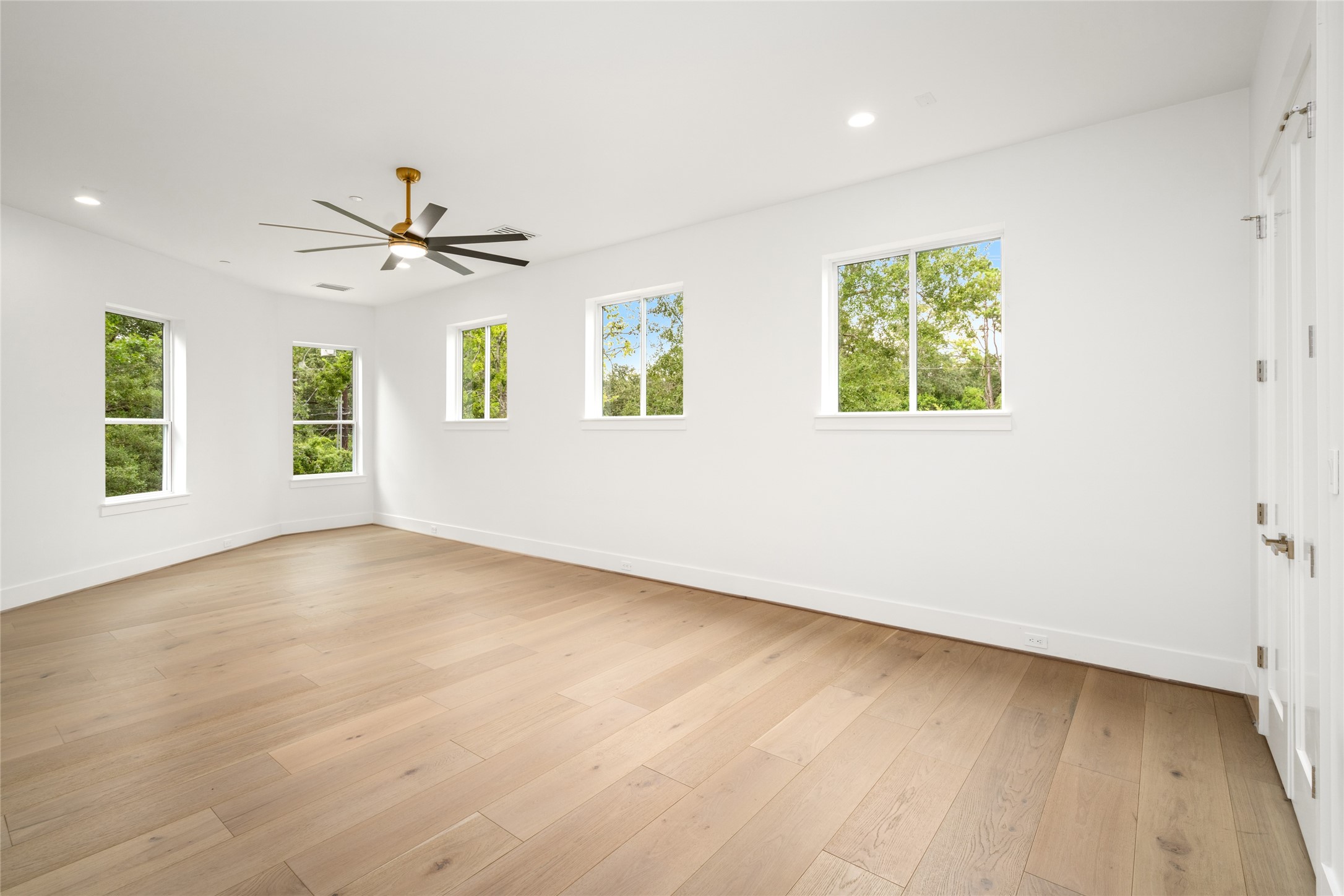 625 Piney Point Road Houston, TX 77024 - Photo 27 of 42 an empty room with windows and ceiling fan